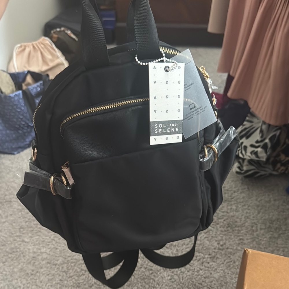 Sleek Black Backpack with Gold Zippers